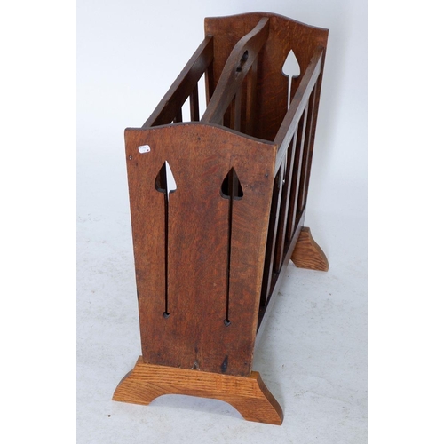 1254 - A Liberty oak magazine rack with pierced tulip cut outs to ends, replacement base 49cm