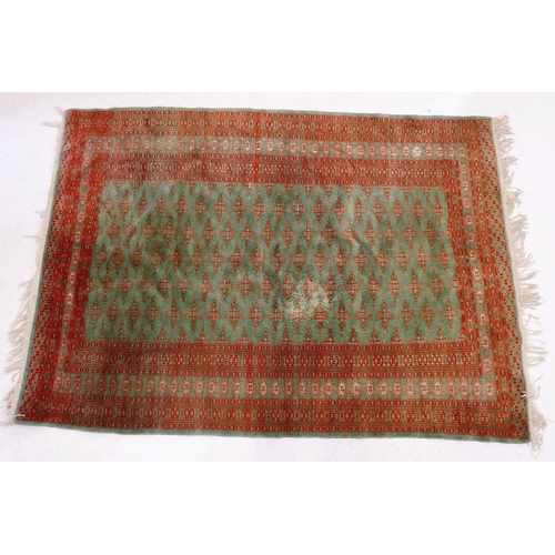 1268 - A Persian silk and cotton rug in red and green 183 x 128cm