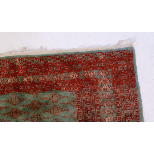 1268 - A Persian silk and cotton rug in red and green 183 x 128cm