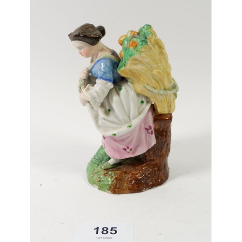 185 - A 19th century porcelain figure of a woman harvesting oranges, 12cm tall