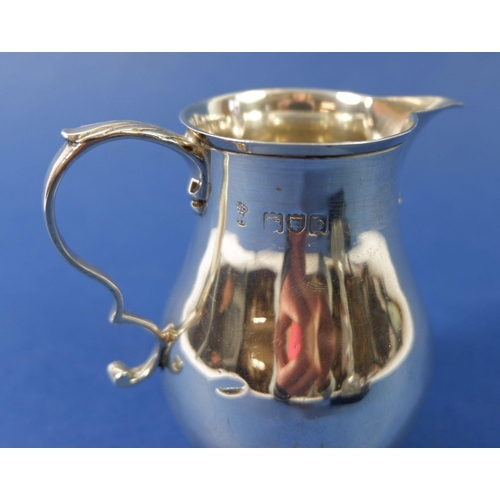 295 - A silver baluster cream jug, London 1897, 118g and a cut glass perfume bottle with silver collar, Bi... 