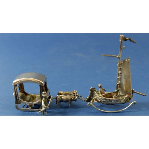 300 - A white metal miniature sleigh pulled by cattle 6cm long, a white metal junk and two stone set orien... 