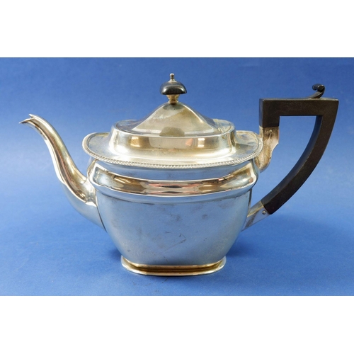 344 - A silver teapot with an ebony handle inscribed to one side, Birmingham 1921, total weight, 634g (han... 