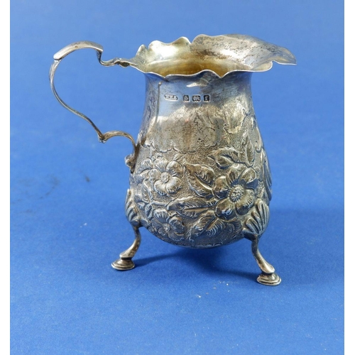 374 - A silver cream jug embossed flowers on hoof feet, Birmingham 1905, 91g