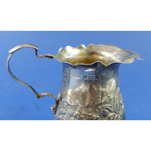 374 - A silver cream jug embossed flowers on hoof feet, Birmingham 1905, 91g