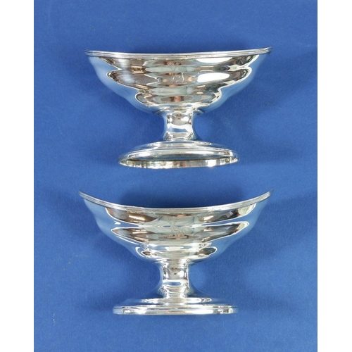 401 - A pair of pedestal silver salt pots with engraved crests, London 1892, 163g