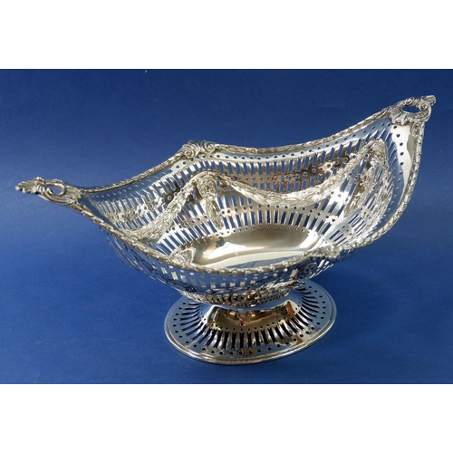 412 - A large silver pierced basket with embossed swags, London 1909 by SS, 518g