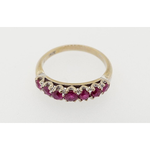 425 - An 18 carat gold seven stone ruby ring (rubies est 1.25 cts) size O