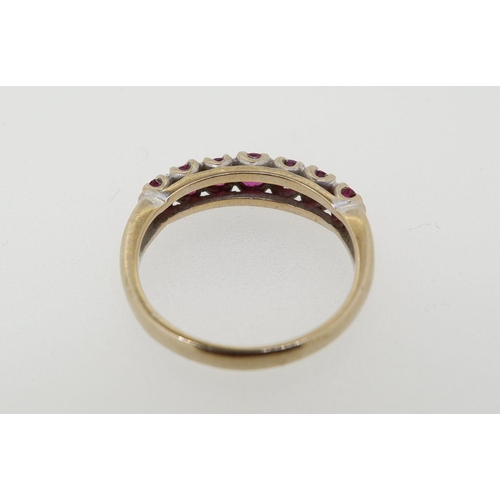 425 - An 18 carat gold seven stone ruby ring (rubies est 1.25 cts) size O