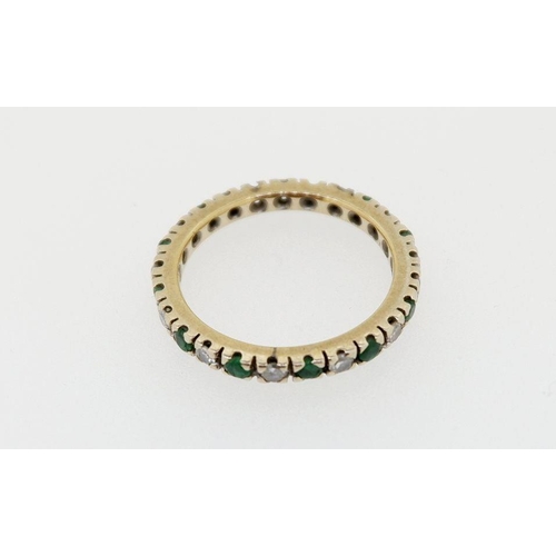 427 - A 9 carat gold eternity ring set emeralds and diamonds, size P to Q