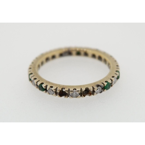 427 - A 9 carat gold eternity ring set emeralds and diamonds, size P to Q