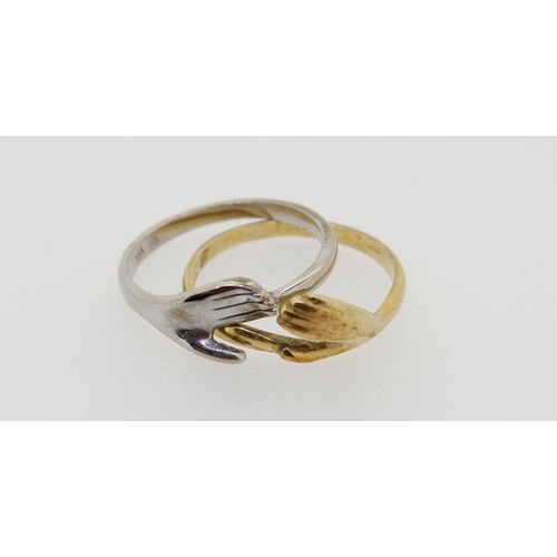 431 - A 14 carat yellow and white gold two part friendship ring with two interlocking hands, 5g