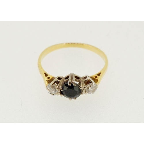 442 - An 18 carat gold ring set sapphire flanked by two diamonds, 2.4g, size N