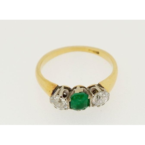 446 - A 18 carat gold ring set emerald flanked by two diamonds (each .4cts each), size O