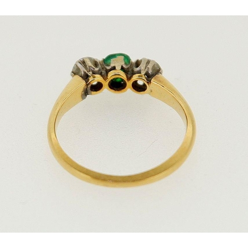 446 - A 18 carat gold ring set emerald flanked by two diamonds (each .4cts each), size O