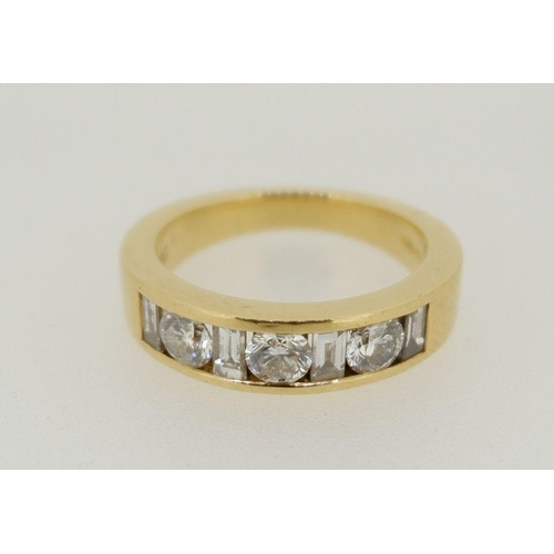 448 - An 18 carat gold ring set three brilliant cut diamonds and four baguette cut diamonds, size N, total... 