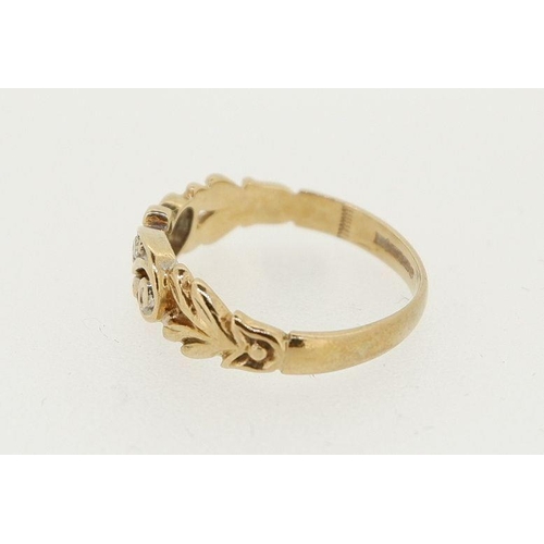 456 - A 9 carat gold ring crossover set three diamonds, one deficient, decorated pierced surround, 1.4g, s... 