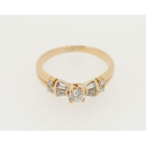 457 - An 18 carat gold ring set brilliant cut diamond flanked by baguette cut diamonds and four smaller st... 