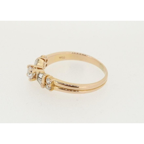 457 - An 18 carat gold ring set brilliant cut diamond flanked by baguette cut diamonds and four smaller st... 