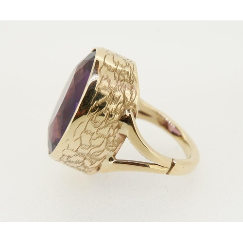 458 - A 9 carat gold handmade large oval cut Brazilian amethyst ring with deep engraved band setting made ... 