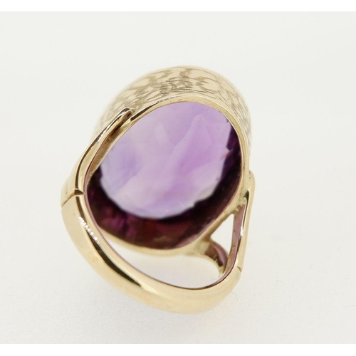 458 - A 9 carat gold handmade large oval cut Brazilian amethyst ring with deep engraved band setting made ... 