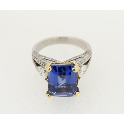 473 - A fine 18ct white gold ring set large emerald cut sapphire flanked by two pear cut diamonds on diamo... 