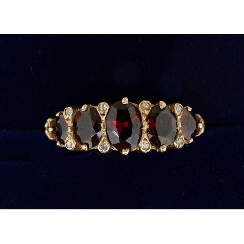 479 - A 9 carat gold five stone garnet ring, size M