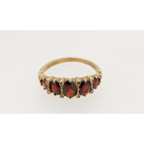 479 - A 9 carat gold five stone garnet ring, size M