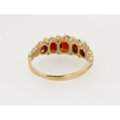 479 - A 9 carat gold five stone garnet ring, size M