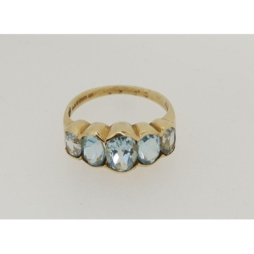 482 - A 9ct gold five stone blue topaz ring, size M to N