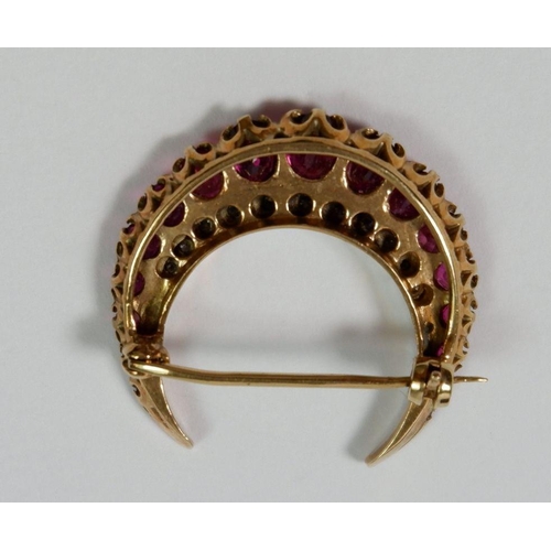 490 - A 9 carat yellow and white gold crescent form brooch set rubies and diamonds, 2.8cm