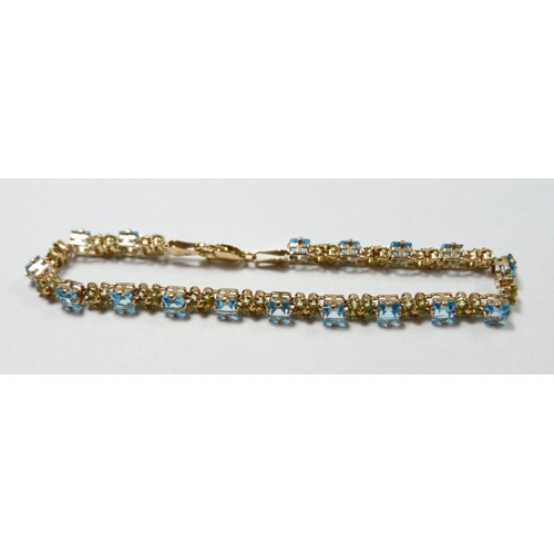 545 - A 9 carat gold bracelet set blue topaz and peridot 8.4g, 19.3cm