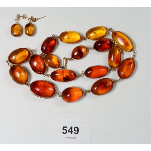 549 - An amber bead necklace set in yellow metal wire and pair of matching drop earrings with stud fitting... 