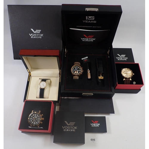 695 - A collection of four gentleman’s wrist watches, three by Vostok Europe and a gold-plated Seiko watch... 