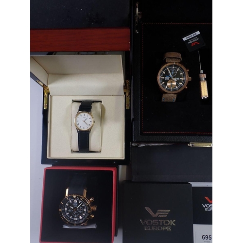 695 - A collection of four gentleman’s wrist watches, three by Vostok Europe and a gold-plated Seiko watch... 