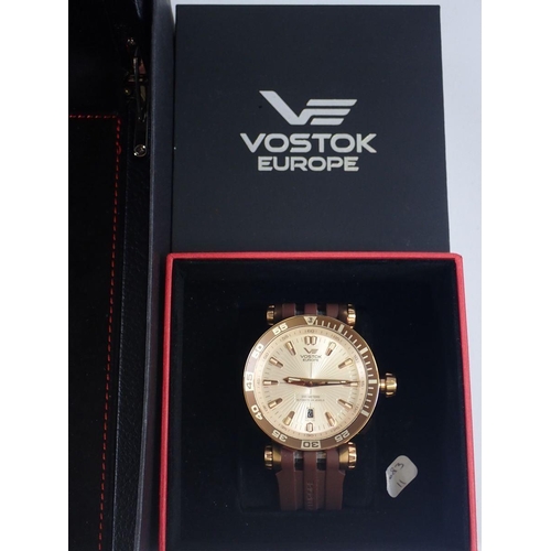 695 - A collection of four gentleman’s wrist watches, three by Vostok Europe and a gold-plated Seiko watch... 