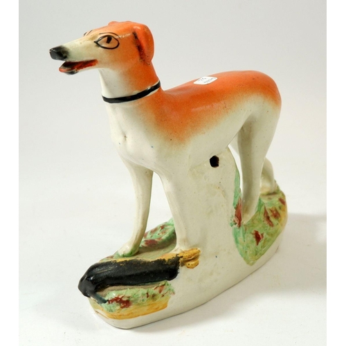 70 - A Victorian Staffordshire greyhound, 17cm tall and similar zebra