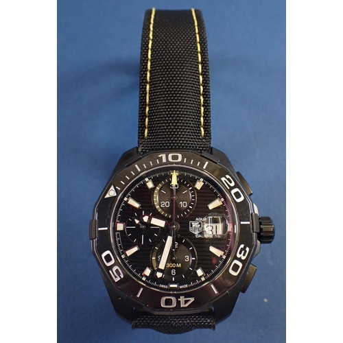 707 - A gentleman’s black ceramic Tag Heuer Aquaracer wrist watch with black fabric strap and yellow stitc... 