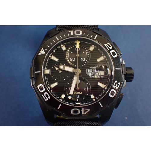 707 - A gentleman’s black ceramic Tag Heuer Aquaracer wrist watch with black fabric strap and yellow stitc... 