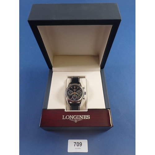 709 - A fine Longines column wheel chronograph wrist watch on black leather strap with automatic movement,... 