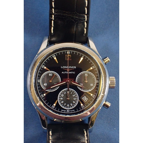 709 - A fine Longines column wheel chronograph wrist watch on black leather strap with automatic movement,... 