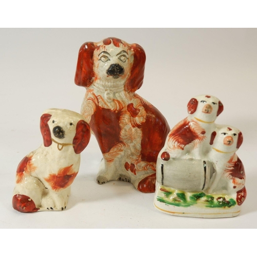 78 - A Victorian Staffordshire group two dogs with a barrel, 11cm and two other small Victorian dogs