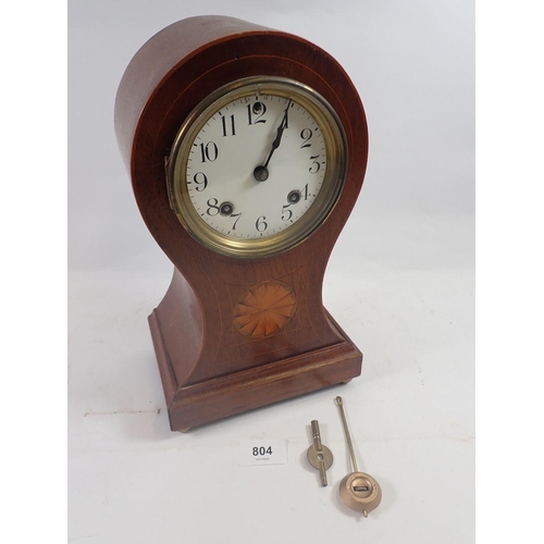 804 - An Edwardian mahogany balloon form clock with satinwood paterae, 31cm, with key and pendulum