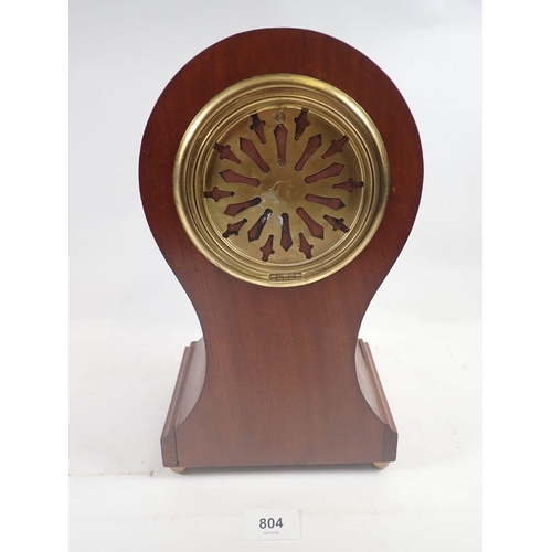 804 - An Edwardian mahogany balloon form clock with satinwood paterae, 31cm, with key and pendulum