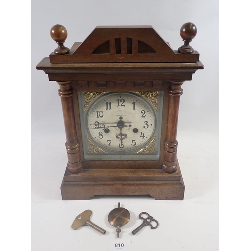 810 - A Victorian oak mantel clock with silvered dial, 35cm tall