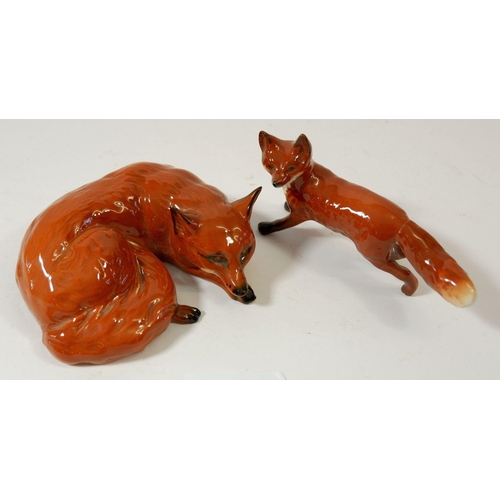 83 - A Beswick fox standing and another reclining