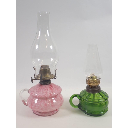 869 - A Victorian mottled pink glass finger lamp and a green glass one