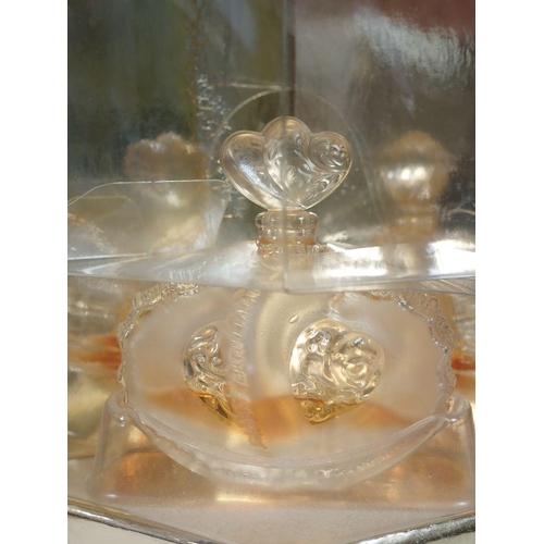 873 - A Lalique set of three miniature perfume bottles 'Les Facons' collection