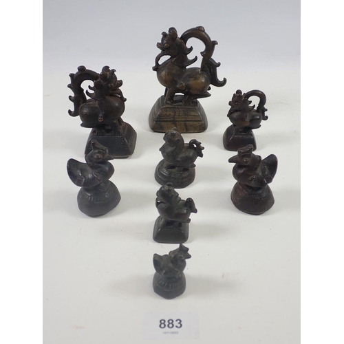 883 - A collection of eight Chinese bronze opium weights in the form of dragons and birds, largest 12cm