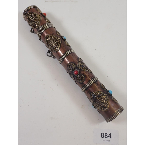 884 - An Indian copper and brass scroll holder inset coloured stones, 24cm